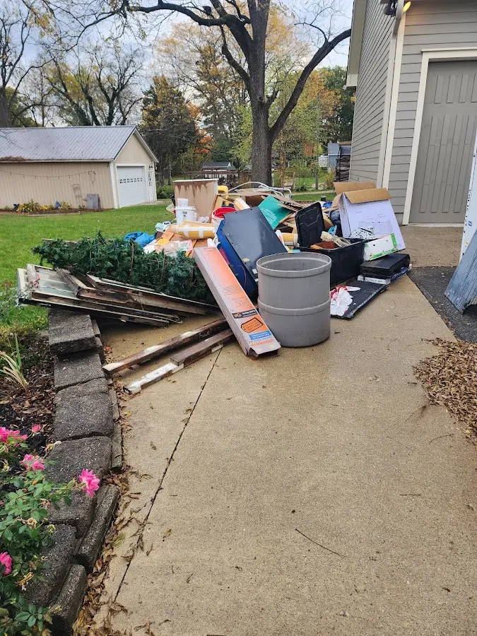 Dumpster being loaded with debris for Commercial Dumpster Rental in Arlington